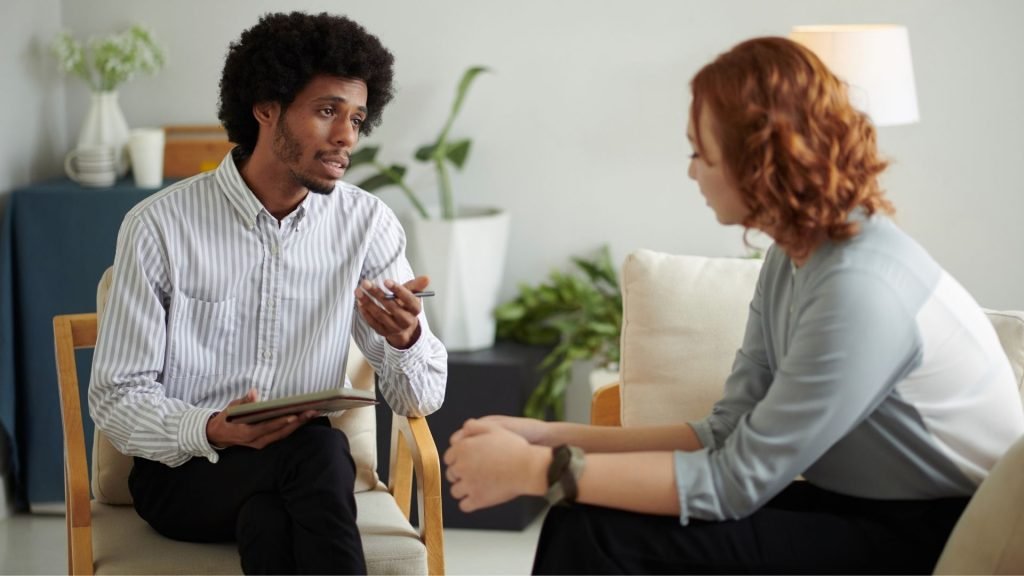 Person discussing anxiety treatment options with a mental health professional.