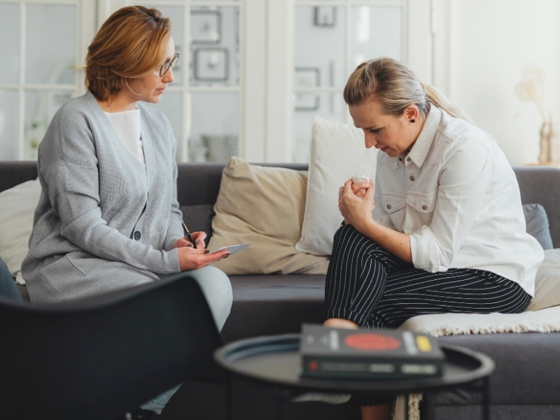 therapist talks about addiction therapy to patient