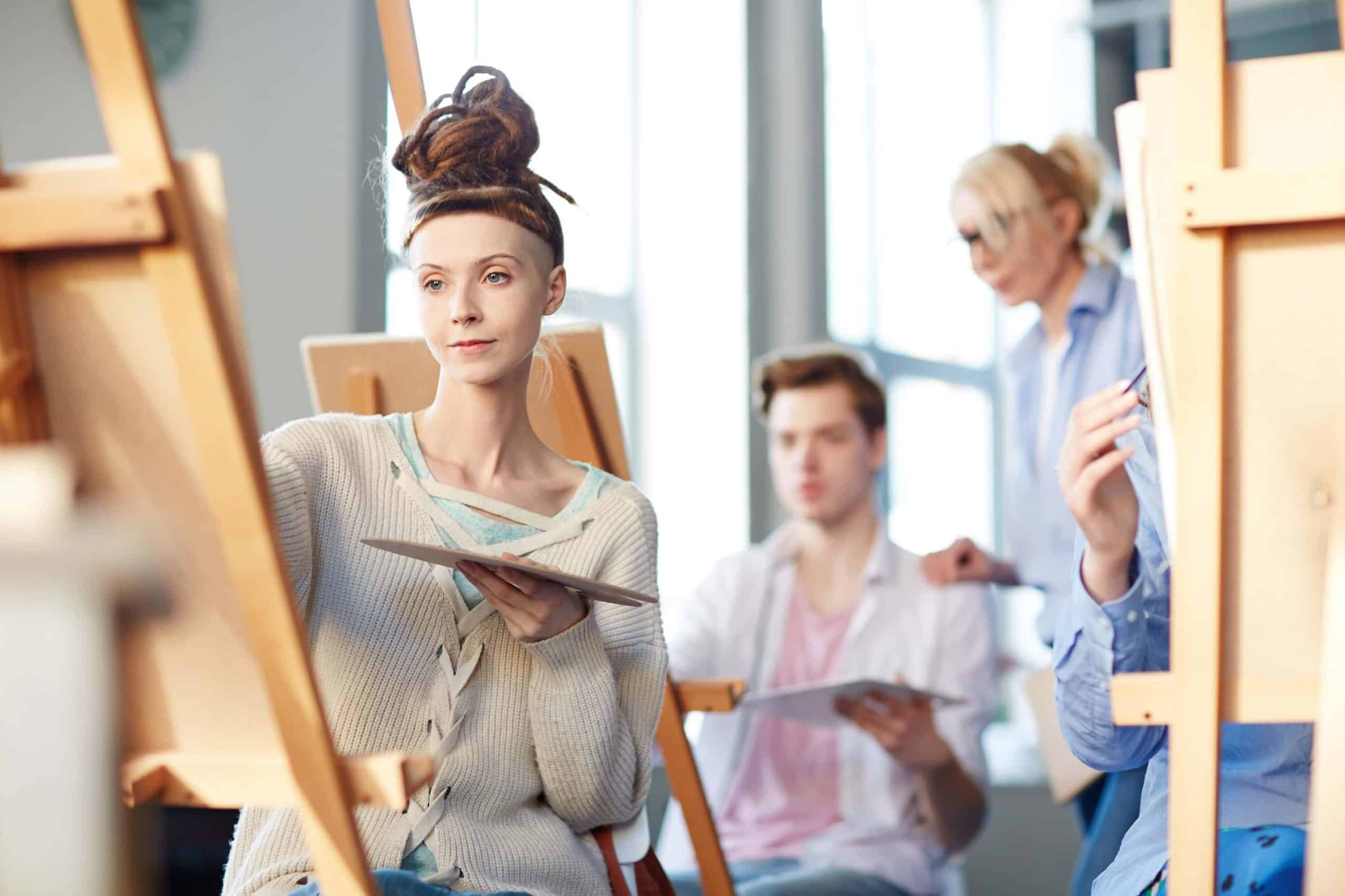 Art therapy class, people painting with easels