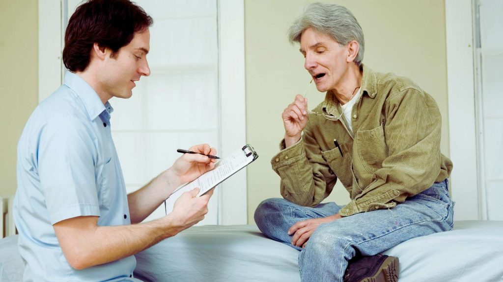 Clinician speaking with a client during a residential drug treatment intake meeting