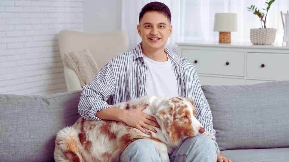 Man on A Couch with his dog at a Rehab That Allows Pets