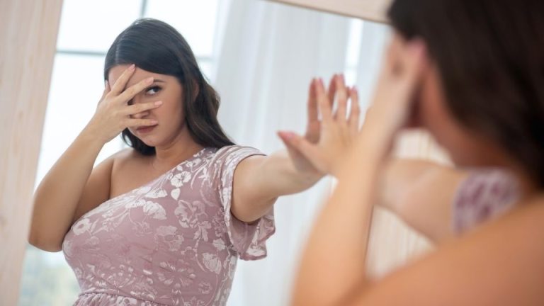 Can SSRIs Change Your Personality a woman examines herself in the mirror pondering this question.