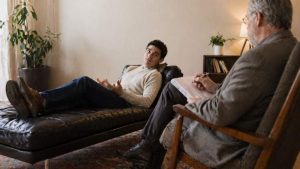 Does Aetna Cover Rehab Your Guide to Addiction Treatment Benefits hero image of a person in therapy.