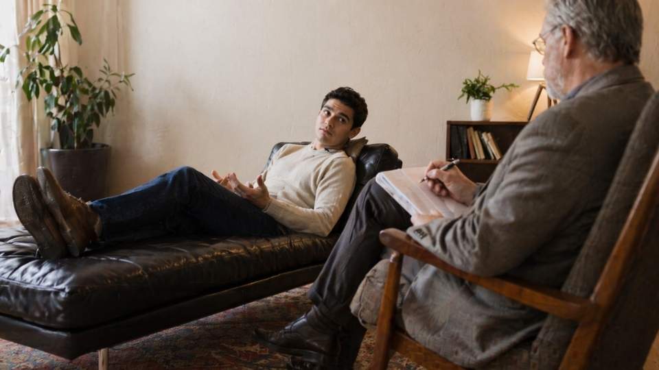 Does Aetna Cover Rehab Your Guide to Addiction Treatment Benefits hero image of a person in therapy.