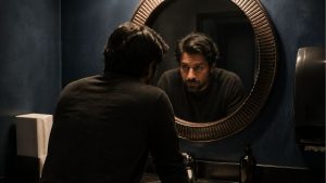 Does Weed Make You Lose Weight Cannabis, Metabolism, and the Truth hero image of man looking at their weight loss in a mirror.