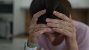 Adderall Withdrawal hero image of a woman looking down struggling with adderall.