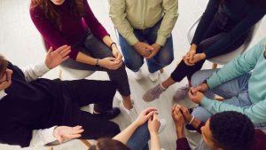 How Much Does Rehab Cost With Insurance? hero image of group therapy.