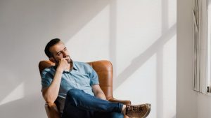 What Is Highmark? hero image of a man thinking about the answer in a chair