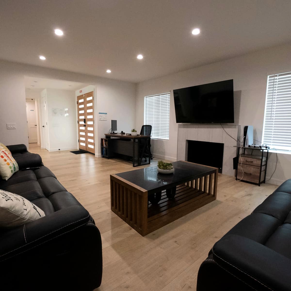 Bright Paths Recovery Living Room area with couches, table and hanging TV